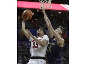 Louisville's Jordan Nwora (33) shoots against Notre Dame's Nate Laszewski (14) during the first half of an NCAA college basketball game in the Atlantic Coast Conference tournament in Charlotte, N.C., Wednesday, March 13, 2019.