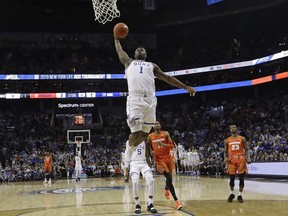 Duke's Zion Williamson (1) goes up to dunk against Syracuse during the first half of an NCAA college basketball game in the Atlantic Coast Conference tournament in Charlotte, N.C., Thursday, March 14, 2019.