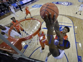 Duke's Zion Williamson, right, dunks against Syracuse during the second half of an NCAA college basketball game in the Atlantic Coast Conference tournament in Charlotte, N.C., Friday, March 15, 2019.