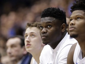 Duke's Zion Williamson, second from right, watches from the bench during the first half of the team's NCAA college basketball game against Wake Forest in Durham, N.C., Tuesday, March 5, 2019.