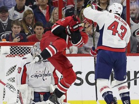 Carolina Hurricanes' Nino Niederreiter (21) tries to score on Washington Capitals goalie Braden Holtby as Capitals' Tom Wilson (43) defends during the first period of an NHL hockey game in Raleigh, N.C., Thursday, March 28, 2019.