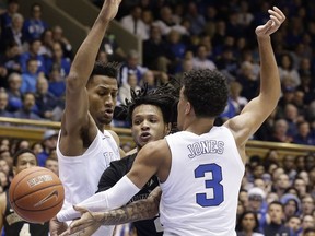 Duke's Javin DeLaurier, left, and Tre Jones (3) guard Wake Forest's Sharone Wright Jr. during the first half of an NCAA college basketball game in Durham, N.C., Tuesday, March 5, 2019.