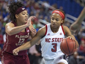 North Carolina State's Kai Crutchfield drives against Florida State's Nausia Woolfolk during an NCAA college basketball game in the Atlantic Coast Conference women's tournament in Greensboro, N.C., Friday, March 8, 2019.