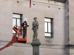 A workman prepares a Confederate staute for removal, Tuesday, March 12, 2019, in Winston-Salem, N.C. Crews began removing the Confederate statue Sunday from the grounds of an old courthouse. North Carolina has been at the forefront of the debate over what to do with Confederate monuments as one of three southern states with the most statues, according to the Southern Poverty Law Center.
