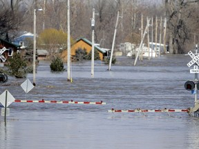 A railroad crossing is flooded with water from the Platte River, in Plattsmouth, Neb., Sunday, March 17, 2019. Hundreds of people remained out of their homes in Nebraska, but rivers there were starting to recede. The National Weather Service said the Elkhorn River remained at major flood stage but was dropping.