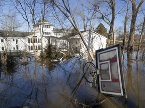 A wayward basketball hoop is seen behind a flooded home Friday, March 22, 2019, in Bellevue, Neb. Flooding in Nebraska has caused an estimated $1.4 billion in damage. The state received Trump's federal disaster assistance approval on Thursday.