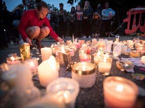 Candles are placed to commemorate victims of Friday's shooting, outside the Al Noor mosque in Christchurch, New Zealand, Monday, March 18, 2019.