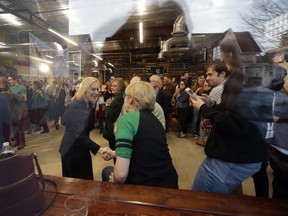 Democratic presidential candidate Sen. Kirsten Gillibrand, D-N.Y., left, shakes hands as she arrives at a campaign meet-and-greet at To Share Brewing, Friday, March 15, 2019, in Manchester, N.H.