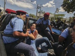 Police detain protesters in Managua, Nicaragua, Saturday, March 16, 2019. Nicaragua's government banned opposition protests in September and police broke up Saturday's attempt at a demonstration to pressure the government to release hundreds of protesters held in custody since 2018.