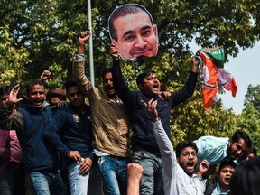In this file photo taken on February 16, 2018 Indian supporters of the Congress Party shout slogans against billionaire jeweller Nirav Modi during a protest in New Delhi. - Indian authorities on March 8, 2019 demolished the seafront bunglow of fugitive billionaire jeweller Nirav Modi worth over $14 million for violating environmental regulations, officials said.