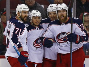 Columbus Blue Jackets right wing Cam Atkinson (13) celebrates with teammates after scoring a goal during the first period of an NHL hockey game against the New Jersey Devils, Tuesday, March 5, 2019, in Newark, N.J.