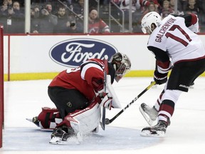 New Jersey Devils goaltender MacKenzie Blackwood, left, blocks a shootout shot by Arizona Coyotes center Alex Galchenyuk (17) during an NHL hockey game, Saturday, March 23, 2019, in Newark, N.J. The Devils on 2-1 in a shootout.