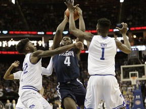 Seton Hall guard Myles Cale (22) and Seton Hall forward Michael Nzei (1) block Villanova forward Eric Paschall (4) as Paschall goes toward the basket during the first half an NCAA college basketball game, Saturday, March 9, 2019, in Newark, NJ.