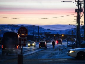 People make their way through Iqaluit, Nunavut. The territory marks its 20th anniversary on Monday.