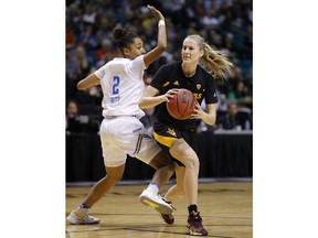 Arizona State's Courtney Ekmark passes around UCLA's Ahlana Smith during the first half of an NCAA college basketball game at the Pac-12 women's tournament Friday, March 8, 2019, in Las Vegas.
