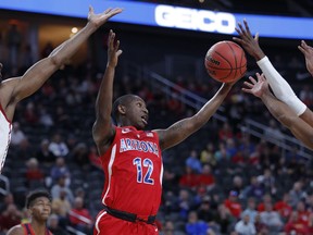 Arizona's Justin Coleman grabs a rebound against Southern California during the first half of an NCAA college basketball game in the first round of the Pac-12 conference tournament Wednesday, March 13, 2019, in Las Vegas.