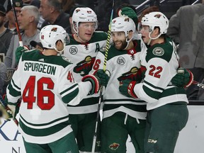 Minnesota Wild players celebrate after Jason Zucker, second from right, scored against the Vegas Golden Knights during the first period of an NHL hockey game Friday, March 29, 2019, in Las Vegas.
