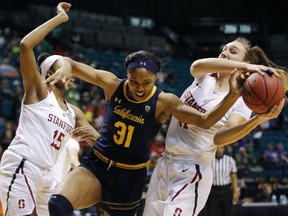 Stanford's Maya Dodson, left, and Alanna Smith, right, battle for the ball with California's Kristine Anigwe during the first half of an NCAA college basketball game at the Pac-12 women's tournament Friday, March 8, 2019, in Las Vegas.