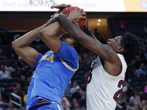 Arizona State's Romello White, right, fouls UCLA's Moses Brown during the first half of an NCAA college basketball game in the quarterfinals of the Pac-12 men's tournament Thursday, March 14, 2019, in Las Vegas.