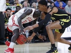Utah's Both Gach, left, and Oregon's Kenny Wooten scramble for the ball during the first half of an NCAA college basketball game in the quarterfinals of the Pac-12 men's tournament Thursday, March 14, 2019, in Las Vegas.