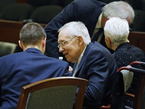 Former U.S. Sen. Harry Reid, second from left, sits in court Tuesday, March 26, 2019, in Las Vegas. A jury in Nevada heard opening arguments Tuesday in Reid's lawsuit against the maker of a flexible exercise band that he says slipped from his hand while he used it in January 2015, causing him to fall and suffer lasting injuries including blindness in one eye.