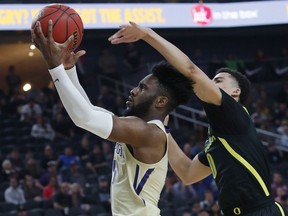 Washington's Jaylen Nowell shoots around Oregon's Will Richardson during the first half of an NCAA college basketball game in the final of the Pac-12 men's tournament Saturday, March 16, 2019, in Las Vegas.