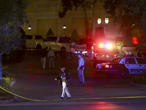 Las Vegas police officers investigate outside of the north valet at the Bellagio after police fired at a robbery suspect in Las Vegas on Friday, March 15, 2019.
