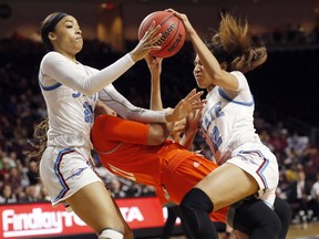 New Mexico State guard Dominique Mills, left, and teammate Kalei Atkinson (22) go after a loose ball over Texas-Rio Grande Valley guard Quynne Huggins (11) during an NCAA college basketball game in the championship of the Western Athletic Conference women's tournament, Saturday, March 16, 2019, in Las Vegas.