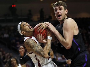 New Mexico State guard Trevelin Queen (20) and Grand Canyon's Alessandro Lever vie for a rebound during the first half of an NCAA college basketball game for the Western Athletic Conference men's tournament championship Saturday, March 16, 2019, in Las Vegas.