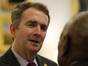 FILE - In this Feb. 22, 2019 file photo, Virginia Gov. Ralph Northam greets members of the Richmond 34 for a breakfast at the Governors Mansion at the Capitol in Richmond, Va. Northam's medical school has won a national award for fostering diversity as it weathers the scandal ignited by a racist photograph from its 1984 yearbook. School president Richard V. Homan picked up the award Friday, March 8 at a conference in Philadelphia.