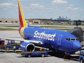 FILE - In this July 17, 2018 file photograph, ramp workers prepare a Southwest Airlines Boeing 737 for departure to Denver from Minneapolis International Airport in Minneapolis. Southwest is suing its mechanics' union over what it claims is an illegal work slowdown that is grounding planes and disrupting flights. The airline filed the lawsuit against the Aircraft Mechanics Fraternal Association late Thursday, Feb. 28, 2019 in federal district court in Dallas.