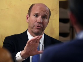 FILE - In this Feb. 12, 2019 file photo, Presidential candidate and former Rep. John Delaney, D-Md., speaks during a roundtable event on climate change in Portsmouth, N.H. Ahead of Sunday, March 31 fundraising deadline for the first quarter, the underdogs of the Democratic primary were in a mad dash to coax as little as $2 from grassroots donors. It's all part of their bid to clear a new threshold from the Democratic National Committee to earn one of 20 highly coveted spots in presidential debates that will begin in June.
