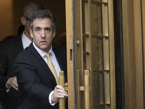 In this Aug. 21, 2018, file photo, Michael Cohen leaves Federal court, in New York. Newly released documents show the FBI was investigating President Donald Trump's former personal attorney and fixer for nearly a year before agents raided his home and office. A search warrant released Tuesday, March 19, 2019 shows the federal inquiry into Cohen had been going on since July 2017,  far longer than had previously been known.