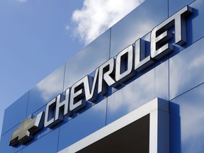 FILE - This April 26, 2017 file photo shows a Chevrolet sign at a Chevrolet dealership in Richmond, Va. Less than a week after a series of critical tweets from President Donald Trump over an Ohio plant closure, General Motors is announcing plans to add 400 jobs and build a new electric vehicle at a Michigan factory. The company said Friday, March 22, 2019,  it will spend $300 million in Orion Township to build a Chevrolet vehicle based on the battery-powered Bolt.