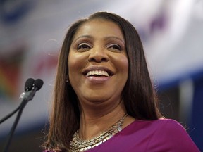 FILE - In this Jan. 6, 2019 file photo, Attorney General of New York, Letitia James, smiles during an inauguration ceremony in New York. James has opened a civil investigation into President Donald Trump's business dealings, taking action after his former lawyer told Congress he exaggerated his wealth to obtain loans. A person familiar with the inquiry said James issued subpoenas Monday, March 11, to Deutsche Bank and Investors Bank seeking records related to four Trump real estate projects and his failed 2014 bid to buy the NFL's Buffalo Bills.