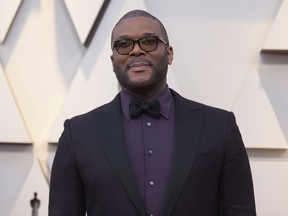 FILE - In this Feb. 24, 2019 file photo, Tyler Perry arrives at the Oscars at the Dolby Theatre in Los Angeles.  Less than a day after the family of a slain single mother of four launched a fundraising appeal, Perry has lent his support.  News outlets report Perry offered to take care of the family's rent to stave off eviction, arrange for 45-year-old Tynesha Evans' body to be flown to Wisconsin for burial and cover her 18-year-old daughter's tuition at Spelman College so she doesn't have to drop out.