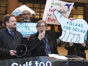 FILE - In this Feb. 15, 2018 file photo, Judith Enck, center, former regional administrator for the Environmental Protection Agency addresses those gathered at a protest against President Trump's plan to expand offshore drilling for oil and gas in Albany, N.Y.  A U.S. judge in Alaska says President Donald Trump exceeded his authority when he reversed a ban on offshore drilling in vast parts of the Arctic Ocean and dozens of canyons in the Atlantic Ocean. Judge Sharon Gleason in a ruling late Friday, March 29, 2019 threw out Trump's executive order that overturned the ban implemented by President Barack Obama.