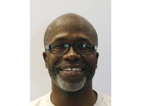 Keith Smith is shown in an undated photo provided by the Baltimore Police Department. On March 3, 2019 the Baltimore Smith a truck driver who blamed his wife's slaying on a case of charity gone wrong was being flown back to Maryland's biggest city on Wednesday, March 20, 2019 along with his daughter to face murder charges in a case that drew international attention. (Baltimore Police Department via AP)