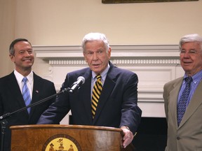 FILE - In this Dec. 19, 2011 file photo, former Maryland Gov. Harry Hughes, center, joins Gov. Martin O'Malley, left, and former Gov. Parris Glendening, right,  in Annapolis. Hughes, who prided himself on restoring public faith in the political process, has died. He was 92. In a statement on Hughes' passing Gov. Larry Hogan said Wednesday, March 13, 2019  that flags will be flown at half-staff until sunset of the day of interment.