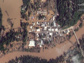 This Thursday, Feb. 28, 2019 satellite image provided by DigitalGlobe shows The Russian River flooding Guerneville, Calif.   The storm-swollen river is slowly receding after causing extensive flooding, but more rainfall is expected Friday night and Saturday. (DigitalGlobe, a Maxar company via AP)