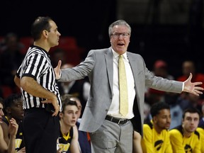 FILE - In this Jan. 7, 2018, file photo, Iowa coach Fran McCaffery, right, speaks with an official during the first half of the team's NCAA college basketball game against Maryland in College Park, Md. McCaffery was suspended for two games for a profanity-laced tirade directed toward the refs last month. He has a history: Both he and his wife were ejected from a game in 2006 for swearing at the officials.