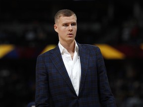 FILE - In this March 14, 2019, file photo, Dallas Mavericks forward Kristaps Porzingis stands during the second half of the team's NBA basketball game against the Denver Nuggets in Denver. An attorney for Porzingis acknowledges that a woman has accused the NBA star of rape, but "unequivocally" denies the allegation. Lawyer Roland Riopelle said Saturday, March 30, that the claim against the Dallas Maverick was part of an extortion attempt that is being investigated by the FBI.