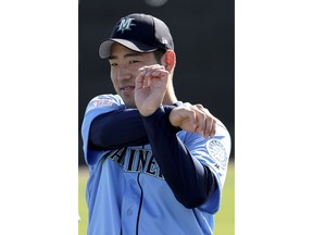 FILE - In this Feb. 12, 2019, file photo, Seattle Mariners pitcher Yusei Kikuchi, from Japan, stretches during spring training baseball practice, in Peoria, Ariz. Aside from all the attention coming his way simply for his talent as a pitcher, Yusei Kikuchi is well aware his first season in the majors will be watched with additional intrigue.