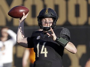 FILE - In this Nov. 24, 2018, file photo, Vanderbilt quarterback Kyle Shurmur (14) passes against Tennessee in the first half of an NCAA college football game, in Nashville, Tenn. There's one quarterback at the NFL scouting combine that New York Giants coach Pat Shurmur has absolutely fallen in love with. It's Kyle Shurmur, his 22-year-old son who threw 50 touchdowns over the last two seasons as Vanderbilt's starter. "Well, I'm extremely proud of him," the Giants coach said.