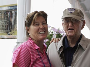 FILE - In this Aug. 15, 2009, file photo, sports writer Dan Jenkins, right, stands next to his daughter, Sally Jenkins, at the PGA Championship at Hazeltine National Golf Club in Chaska, Minn. Jenkins, the sports writing great and best-selling author known for his humor, has died. He was 89. TCU athletic director Jeremiah Donati confirmed Jenkins died Thursday, March 7, 2019, in his hometown of Fort Worth, Texas.