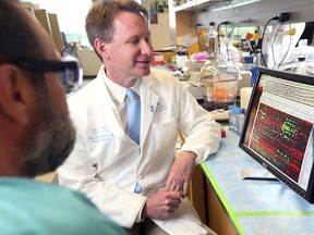 This 2015 photo made available by the Feature Photo Service for IBM shows Dr. Norman Sharpless, director of the University of North Carolina Lineberger Comprehensive Cancer Center, examines DNA sequencing data in Chapel Hill, N.C. On Tuesday, March 12, 2019, The Food and Drug Administration announced that Sharpless will temporarily take charge of the agency next month after the departure of its current chief, Scott Gottlieb.
