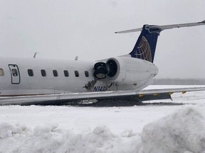 A United Express regional jet that slid off a runway during a snow storm is seen where it came to a rest at Presque Isle International Airport on Monday, March 4, 2019, in Presque Isle, Maine. National Transportation Safety Board investigators arrived in Maine on Tuesday to determine why the United Express regional jet slid off a runway, injuring a pilot and four passengers.
