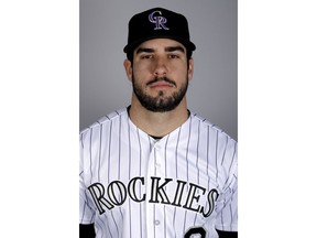 FILE - In this Feb. 20, 2019, file photo, Colorado Rockies' Mike Tauchman poses for a photo in Scottsdale, Ariz. Tauchman needed to face facts: Getting traded to the New York Yankees meant the outfielder had to get rid of the beard he's worn for years.