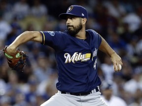 FILE - In this Oct. 16, 2018, file photo, Milwaukee Brewers starting pitcher Gio Gonzalez throws during the first inning of Game 4 of the National League Championship Series baseball game against the Los Angeles Dodgers in Los Angeles. A person familiar with the negotiations tells The Associated Press that left-hander Gonzalez and the New York Yankees have agreed to a minor league contract. The person spoke on condition of anonymity Monday, March 18, 2019, because the agreement had not yet been announced.