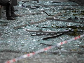FILE - In this July 26, 2011, file photo, the legs of a statue are surrounded by broken glass and debris inside a cordoned off area damaged by a bombing attack in Oslo several days earlier. The attacker, Anders Behring Breivik, raged against Europe's growing Muslim population and claimed to represent what turned out to be an imagined order of Knight crusaders. The March 2019 attack in Christchurch, New Zealand, has drawn comparisons to the attack in Norway.